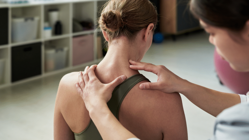 A young woman receives posture correction techniques during her physiotherapy session at Strive.