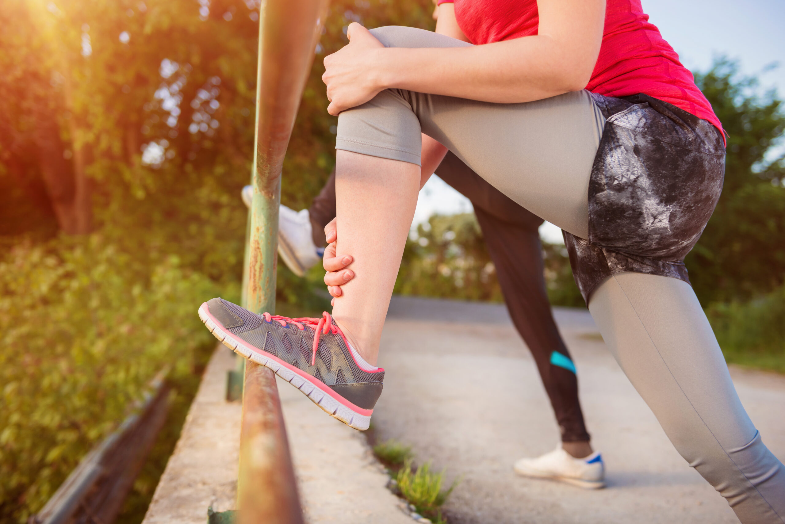 woman stretching hamstring after injury